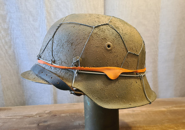 German WWII Helmet M-1942 in Normandy camouflage. Its a original one only the inlet is new